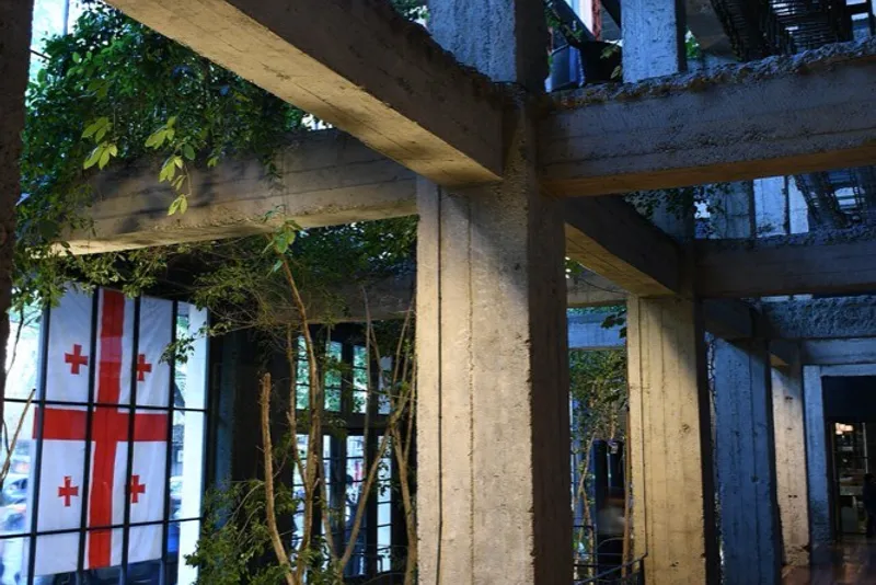 Inside Stamba, a former printing house with concrete beams and plants